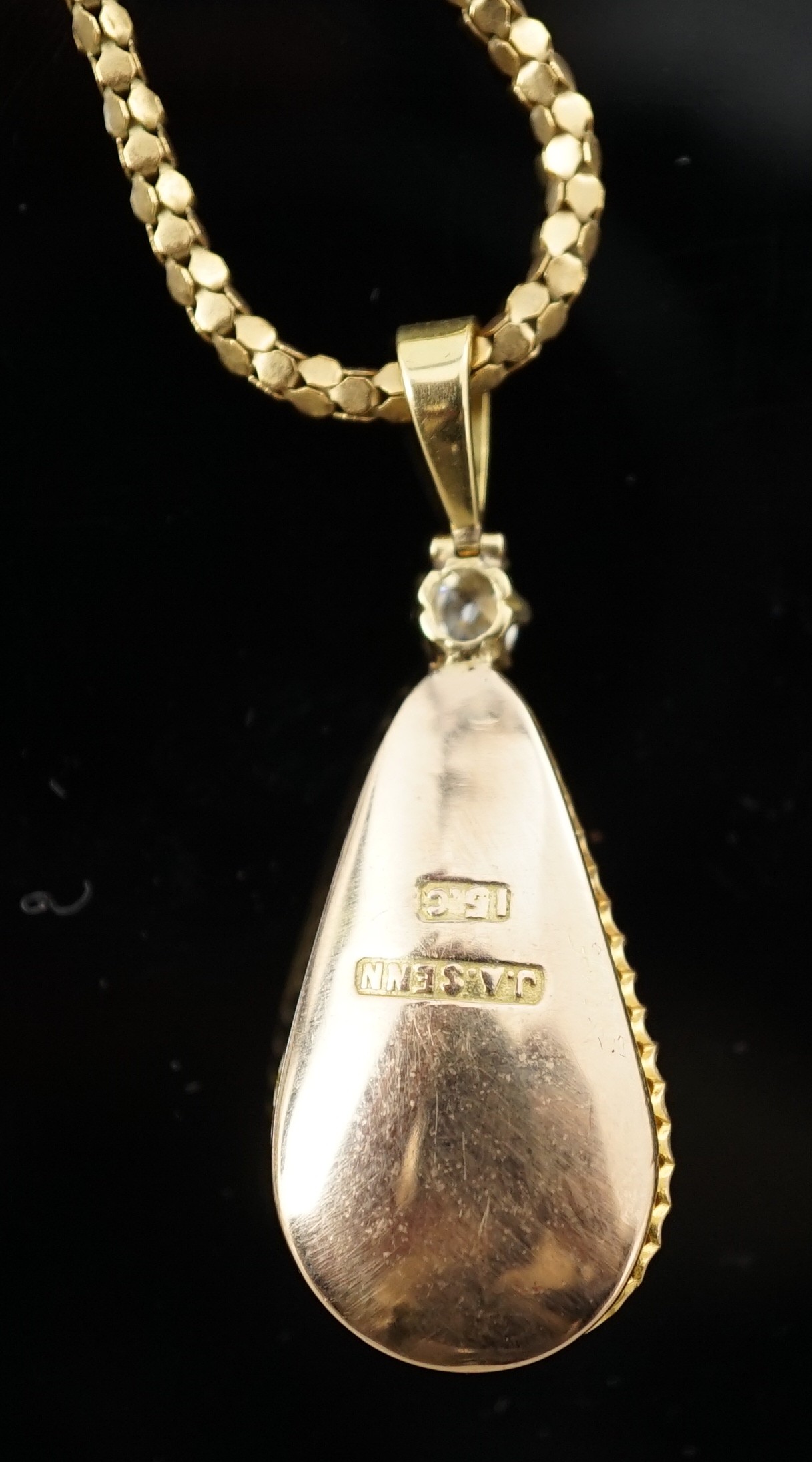 A 15ct gold mounted pear shaped baroque pearl and diamond set pendant, on an associated Italian 9k gold chain